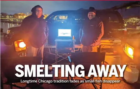  ?? DALE BOWMAN/SUN-TIMES ?? Michael Heredia (left) and Ralph Melendez were among the few taking part in the tradition of smelt netting on opening night last year at Montrose Harbor.