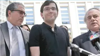  ?? | SETH WENIG/ AP ?? Former pharmaceut­ical CEOMartin Shkreli, center, pictured with his attorneys in New York, was convicted Friday on federal charges he deceived investors in a pair of failed hedge funds.