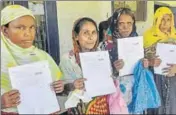  ?? PTI ?? People queue at the office to verify and check their names in the final draft of the NRC at Morigaon on August 4.