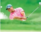  ?? Mike Carlson/The Associated Press ?? ■ Tiger Woods hits from the bunker on the first hole during the third round of the Valspar Championsh­ip golf tournament Saturday in Palm Harbor, Fla.