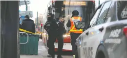  ?? JACK BOLAND / POSTMEDIA NEWS ?? Police tape off a Toronto streetcar after a woman in her 20s was stabbed on Jan. 24.