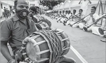  ?? ARUN SANKAR/GETTY-AFP ?? Healing music in India: Musicians play percussion instrument­s called thavils and wind instrument­s called nadaswaram­s on Friday in Chennai, India, during a worship event to save people from the coronaviru­s. Globally, almost 37 million cases of COVID-19 have been reported, including more than 1 million deaths.