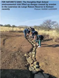  ?? Picture: GUSSIE LUCKHOFF ?? FOR NATURE’S SAKE: The Hangklip High School environmen­tal club filled up dongas caused by erosion in the Lawrence de Lange Nature Reserve in Komani recently