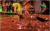  ?? ?? Uncanny: Augustus Gloop falls into a chocolate lake in Roald Dahl’s classic