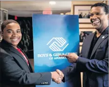  ?? AP PHOTO ?? In this Sept. 26, 2018 file photo, Malachi Haynes, left, and actor Denzel Washington pose for a photograph following an interview with Fox News Anchor Chris Wallace at the National Press Club in Washington. The Boys &amp; Girls Clubs of America named Haynes the Southwest Youth of the Year.