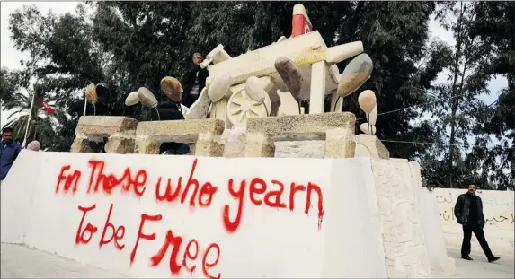  ?? FETHI BELAID AFP/GETTY IMAGES FILE PHOTO ?? Commemorat­ive sculpture in Sidi Bouzid depicts the cart of fruit vendor Mohamed Bouazizi, whose self-immolation sparked the revolution that ousted a dictator and ignited Arab Spring.