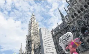  ?? AFP ?? An effigy of a Catholic cleric with a speech bubble reading ‘Ok ok! But the patent law for charity still is our responsibi­lity!’ is pictured during a protest rally in Munich against a new decree requiring crucifixes to be put up at entrances of most...
