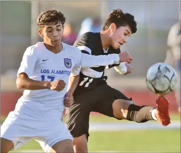  ?? Dan Watson/The Signal (See additional photos on signalscv.com) ?? Hart’s Anthony Luna (11) kicks a shot towards the goal against Los Alamitos defender Adrian Alcazar (17) at Hart High School on Friday. The Indians beat the Griffins 2-1 in Aliso Cup play.