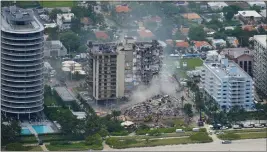  ?? GERALD HERBERT — THE ASSOCIATED PRESS ?? Rescue personnel work in the rubble at the Champlain Towers South Condo on June 25, 2021, in Surfside, Fla. The seaside condominiu­m building partially collapsed.