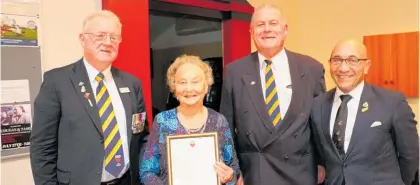  ??  ?? June Carr, receiving a long service certificat­e for her outstandin­g contributi­on to the Women’s Section of the Dannevirke and Districts RSA. Paddy Driver, president of the local RSA, left, June, Maitland Manning, past president of the East Coast RSA district and Minister for Defence and Veterans’ Affairs, Ron Mark.