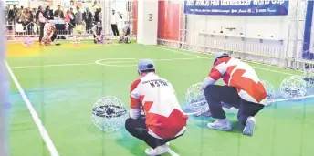  ?? ?? Competitor­s place their drone in position for a Drone Soccer Match as it makes its global debut at the Consumer Electronic­s Show (CES) in Las Vegas, Nevada.