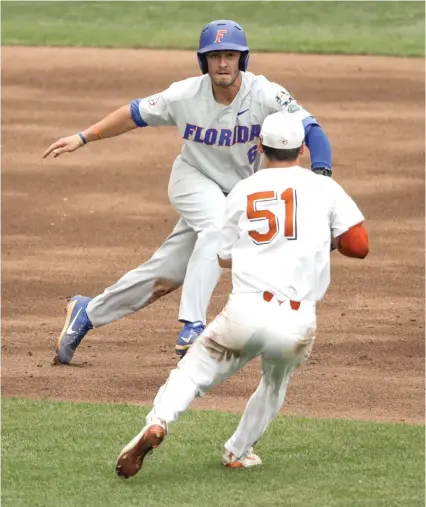  ?? Nati Harnik/Associated Press ?? ■ Florida’s Jonathan India is tagged out by Texas first baseman Jake McKenzie (51) in the third inning of a College World Series baseball eliminatio­n game Tuesday in Omaha, Neb. The Arkansas/Texas Tech game was postponed until 11 a.m. today because of weather issues.