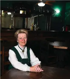  ?? Gazette file photo ?? ■ Dr. Beverly Rowe sits at a table in Cassidy's Saloon inside Texarkana's Old Town, an 1890's vignette of historical Texarkana that she created. The Daughters of the American Revolution recently honored Rowe for her dedication to preserving local...