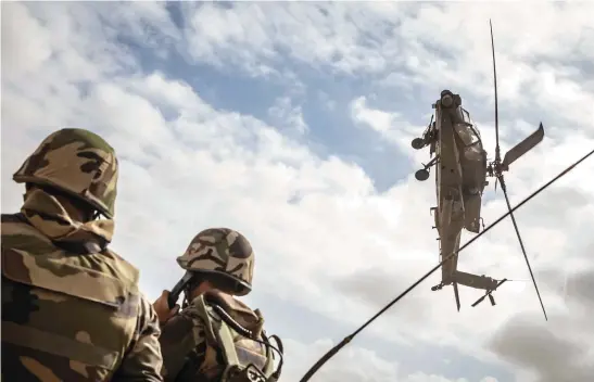  ?? Picture: AFP ?? AIR SUPPORT. A US army AH-64 Apache attack helicopter flies over members of the Moroccan Royal Armed Forces during the ‘African Lion’ military exercise in the Tan-Tan region of southweste­rn Morocco on Thursday.