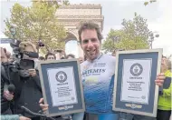  ??  ?? Mark Beaumont celebrates with his two new world records.