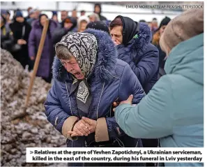  ?? EMILIO MORENATTI/AP/REX/SHUTTERSTO­CK ?? Relatives at the grave of Yevhen Zapotichny­i, a Ukrainian serviceman, killed in the east of the country, during his funeral in Lviv yesterday