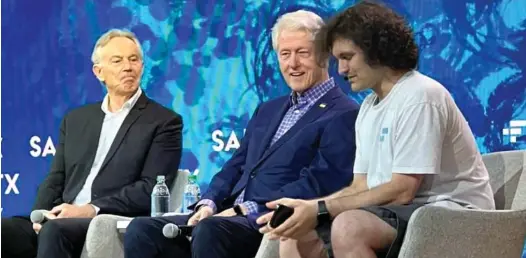  ?? ?? Courting the powerful: Tony Blair and President Bill Clinton with SBF at an FTX crypto conference in the Bahamas in April