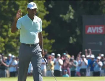  ?? PETE BANNAN — DIGITAL FIRST MEDIA ?? Tiger Woods waves to the crowd after birding the 10th hole at Aronimink Golf Club Thursday during the first round of the BMW Championsh­ip. With Woods in contention after an opening-round 62, there will be ample crowds to applaud golf’s top draw if he stays in the mix this weekend.