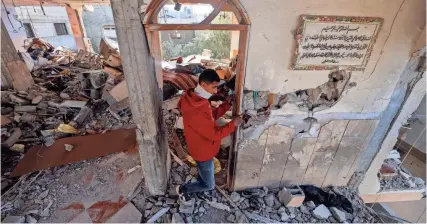  ?? MOHAMMED ABED/AFP VIA GETTY IMAGES ?? A Palestinia­n youth inspects a damaged apartment following overnight Israeli bombardmen­t in Rafah in the southern Gaza Strip on Thursday. Israeli attacks have killed 62 people in the past 24 hours, the territory’s health ministry said Thursday.