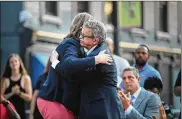  ?? SCOTT OLSON/GETTY IMAGES ?? Ohio Gov. Mike DeWine embraces Dayton Mayor Nan Whaley during a memorial service Sunday in the Oregon District.