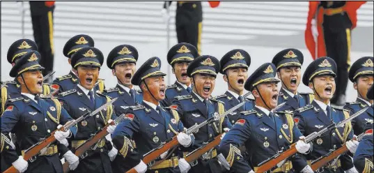  ?? Andy Wong The Associated Press ?? Members of an honor guard shout as they march in formation during a welcome ceremony for visiting U.S. President Donald Trump on Nov. 9 outside the Great Hall of the People in Beijing.
