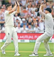  ?? — AFP ?? England’s Chris Woakes (left) celebrates with Ben Stokes after taking a wicket on Saturday.