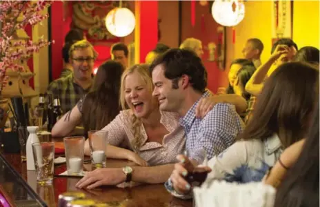  ?? UNIVERSAL PICTURES/TRIBUNE NEWS SERVICE ?? In Trainwreck, Amy Schumer and Bill Hader embody rom-com trope No. 2: Self-destructiv­e woman would rather chase jerks than recognize a great guy.