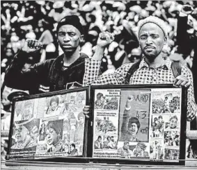  ?? GULSHAN KHAN/GETTY-AFP ?? Mourners watch from the stands of the Orlando Stadium in Soweto during the funeral of the late anti-apartheid champion Winnie Mandizikel­a-Mandela.