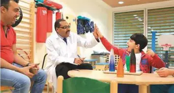  ?? Courtesy: Al Jalila Foundation ?? Majd Radwan Mohammad from Syria, who suffered a stroke, with Dr Haitham Al Bashir at Al ■ Jalila Children’s Specialty Hospital in Dubai, where he was treated.