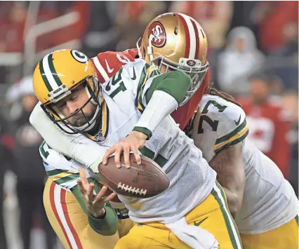  ?? KIRBY LEE-USA TODAY SPORTS ?? Packers quarterbac­k Aaron Rodgers is sacked by 49ers defensive end Arik Armstead in the fourth quarter of the NFC Championsh­ip Game on Sunday. The Packers lost, 37-20, ending their season.