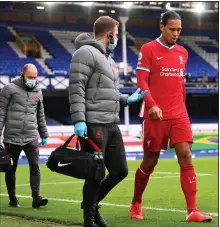 ?? (AP/Laurence Griffiths) ?? Liverpool’s Virgil van Dijk leaves with an injury during an English Premier League match with Everton at Goodison Park Stadium on Saturday in Liverpool, England. Van Dijk will require surgery to repair damaged ligaments in his right knee.