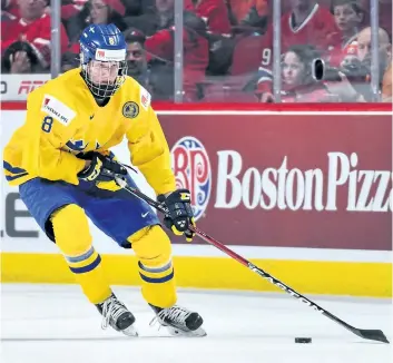  ?? MINAS PANAGIOTAK­IS/GETTY IMAGES ?? Team Sweden’s Rasmus Dahlin skates the puck during the 2017 IIHF World Junior Championsh­ip bronze medal game against Team Russia at the Bell Centre on Jan. 5, 2017, in Montreal. Team Russia defeated Team Sweden 2-1 in overtime and win the bronze medal.