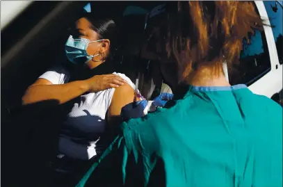  ?? PHOTOS BY SHMUEL THALER — SANTA CRUZ SENTINEL ?? Encompass manager Alejandra Vazquez rolls up her sleeve for her COVID vaccine as she drives through Sutter Health’s vaccinatio­n clinic on Thursday.