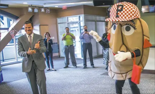  ??  ?? Frank Coonelly, president of the Pittsburgh Pirates, announces Pizza Penny, a new pierogi for the pierogi races at PNC Park.