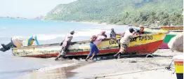  ?? FILE ?? File photo shows fisherfolk pulling a boat along the beach in Alligator Pond, Manchester. Fisherfolk are yet to take up the net insurance policy launched two years ago, which provides coverage for registered fisherfolk vessels, engines, and equipment, a representa­tive from Advantage General Insurance Company has revealed.