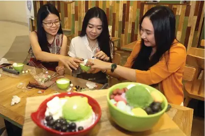  ?? GHOFUUR EKA/JAWA POS ?? MAKANAN TIRUAN: Dari kiri, Jessica Edina, Melisa Sugiono, dan Pamela Velita membuat dessert bowl clay art di Galaxy Mall kemarin.