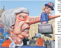  ?? AFP photo ?? Anti-Brexit activists demonstrat­e with a model of May outside the Houses of Parliament in London, as MPs debate alternativ­e alternativ­e options for Brexit ahead of the second round of indicative votes.—