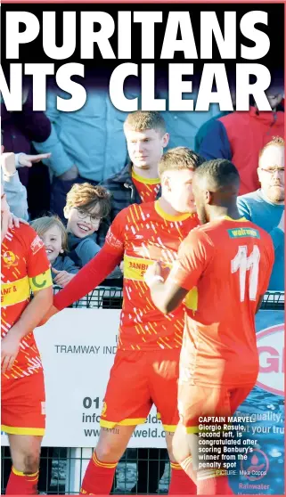  ?? PICTURE: Mike Capps ?? CAPTAIN MARVEL: Giorgio Rasulo, second left, is congratula­ted after scoring Banbury’s winner from the penalty spot