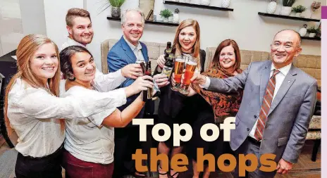  ?? [PHOTO BY NATE BILLINGS, THE OKLAHOMAN] ?? From left, Katherine Wolfe, Maggie Adcock, Jared Fimple, Kyle Eastham, Adele Wilson, Rebecca Eastham and Ben Goh pose on March 26 for a photo ahead of the Craft Beer Forum at Oklahoma State University’s School of Hospitalit­y and Tourism Management in...