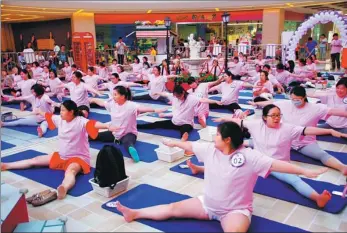  ?? IMAGINECHI­NA ?? Pregnant women practice yoga at a square in Wuhan, Hubei province. More Chinese women are visiting fertility centers abroad to start, or expand, their families.