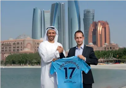  ??  ?? Sultan Al Dhaheri and Damian Willoughby release the T-shirt, which has been specially commission­ed to celebrate the launch of the Extraordin­ary City Story competitio­n, in Abu Dhabi. The shirt will be worn by Manchester City stars during their matches...