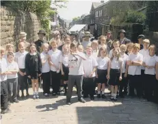  ??  ?? Children from Heptonstal­l School on the film set of ITV drama Jericho