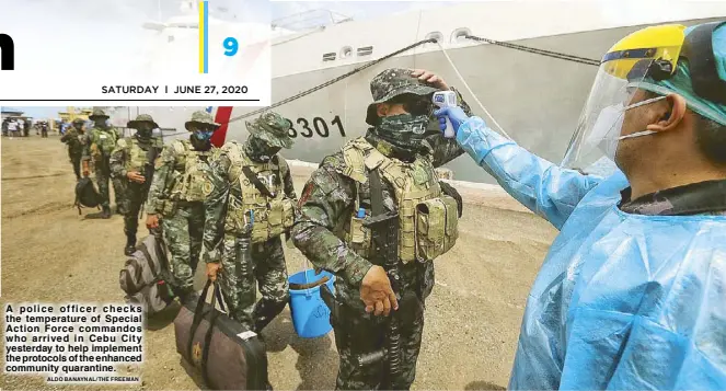  ?? ALDO BANAYNAL/THE FREEMAN ?? A police officer checks the temperatur­e of Special Action Force commandos who arrived in Cebu City yesterday to help implement the protocols of the enhanced community quarantine.