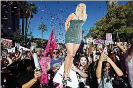  ?? CHRIS PIZZELLO / AP ?? Confetti falls on Britney Spears supporters outside a hearing concerning the pop singer’s conservato­rship at the Stanley Mosk Courthouse on Friday, in Los Angeles. A Los Angeles judge ended the conservato­rship that has controlled Spears’ life and money for nearly 14 years.