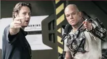  ?? KIMBERLY FRENCH/ COLUMBIA PICTURES/ TRISTAR/ AP FILES ?? Director Neill Blomkamp, left, on the set of the dystopian action thriller Elysium with star Matt Damon.