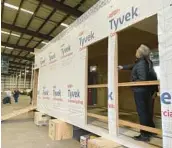  ?? CLAIRE RUSH/AP ?? Oregon Gov. Tina Kotek looks at a mass timber affordable housing prototype, seen as a possible solution to homelessne­ss, at the Port of Portland.