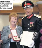  ??  ?? Honoured Cathy receives her British Empire Medal