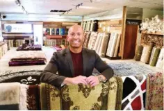  ?? STAFF PHOTO BY ROBIN RUDD ?? Jordan Parker, who recently opened Direct Flooring off Rossville Boulevard, supports the Boulevard Project by giving a percentage of weekend rug sales to efforts to improve the area.