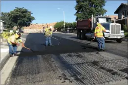  ?? Courtesy photo ?? Workers continue the city’s annual slurry seal and overlay project. Due to work, residents may see mild constructi­on delays for a few weeks.