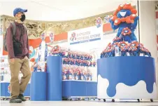  ?? ?? A man walking past a display of “Myaku-Myaku” dolls, the official mascot, at an official store for the 2025 Expo in Osaka.